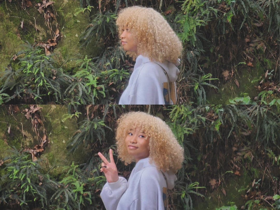 A candid photo of me outside, throwing a peace sign